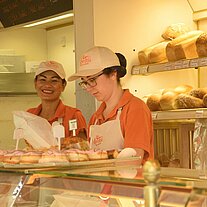 Girls serving in the bakery