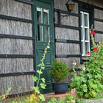 Reethaus mit Bepflanzung am Eingang